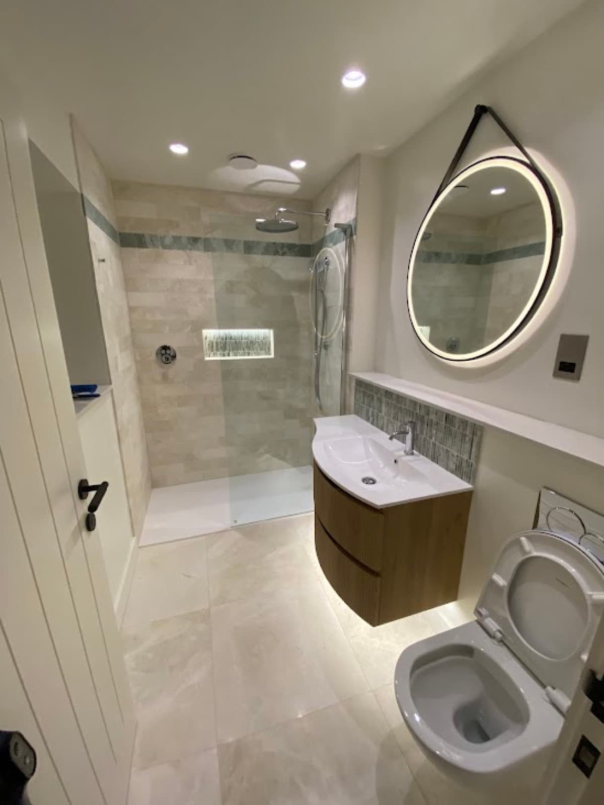 A cleaned bathroom with walk-in shower and vanity unit
