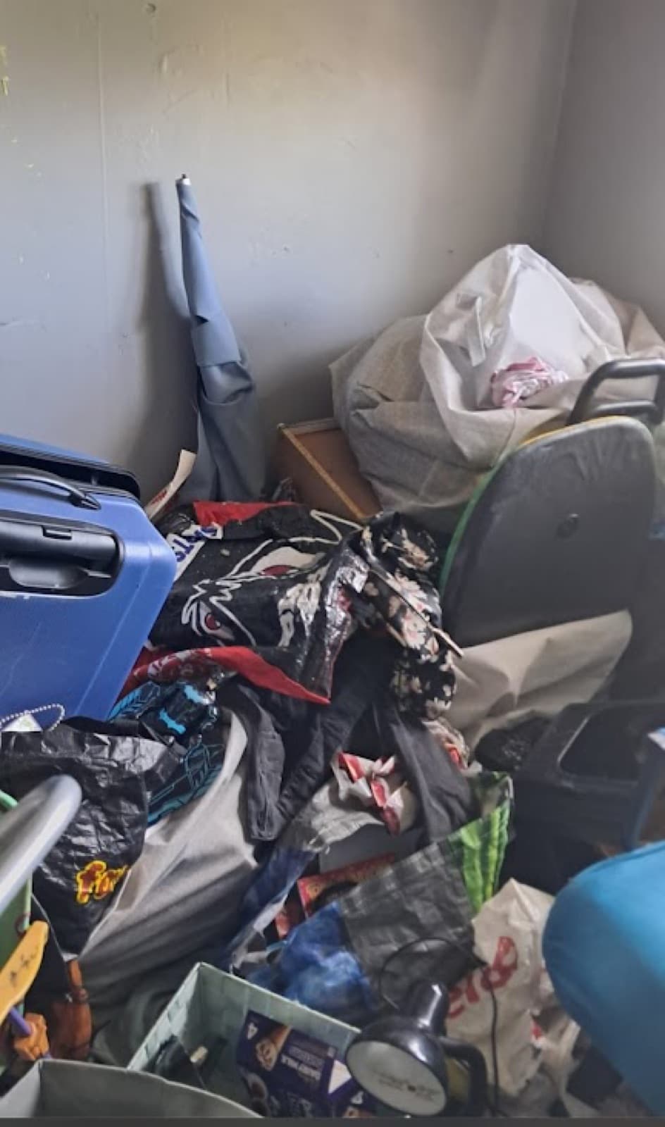 A room filled floor to waist height with accumulated possessions and bagged belongings
